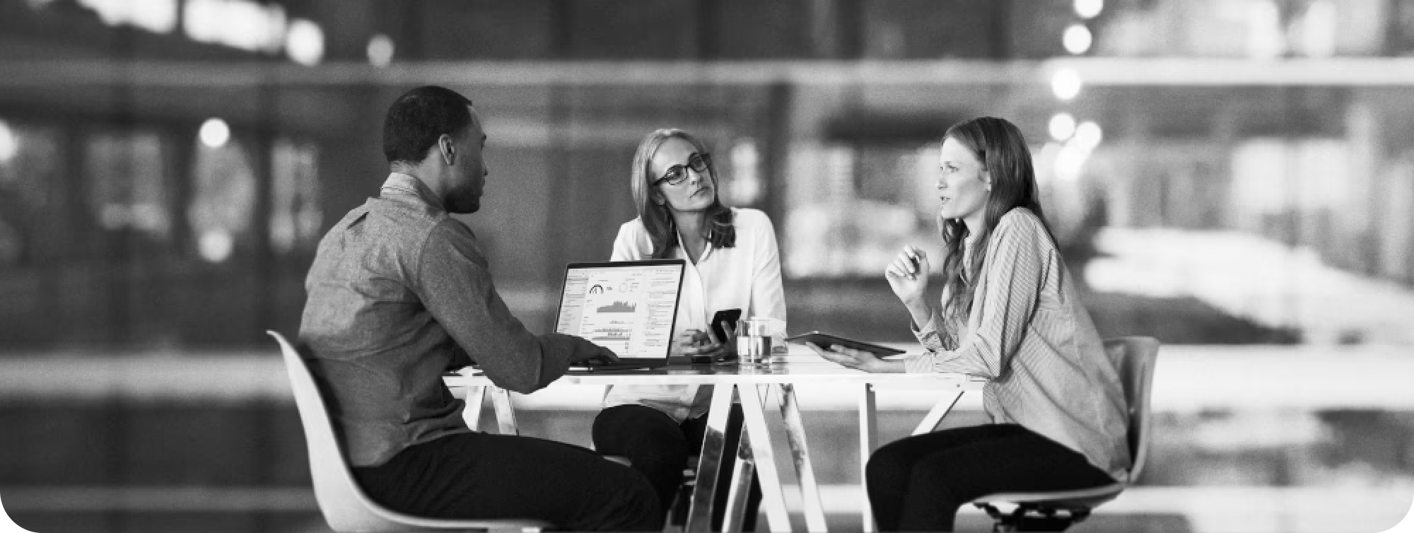 Three agency colleagues seated around a table