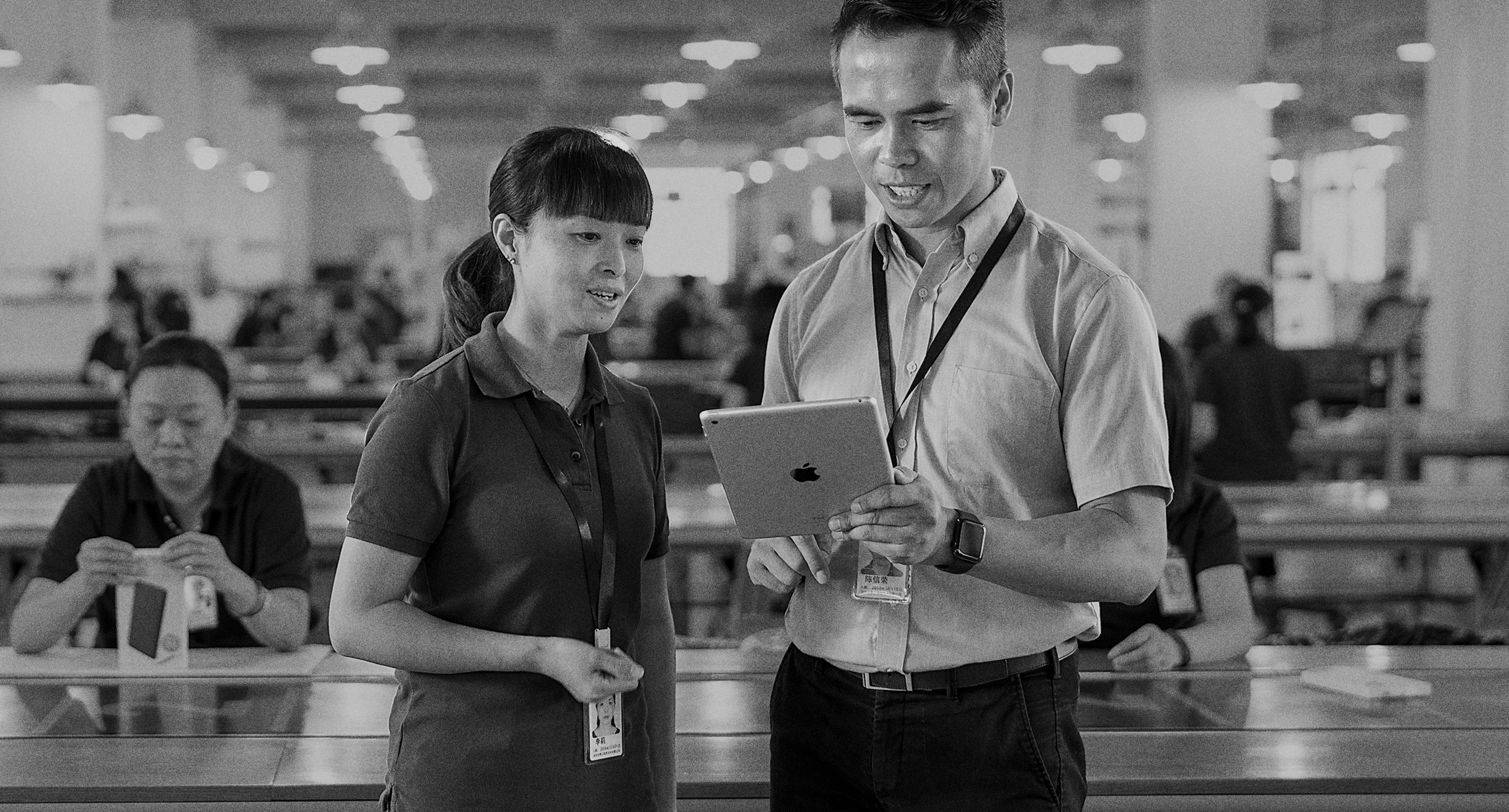 Two Amazon vendor colleagues reviewing a tablet
